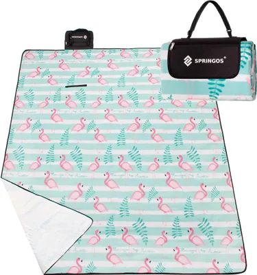 A folded picnic blanket with a flamingo pattern and a carrying case.