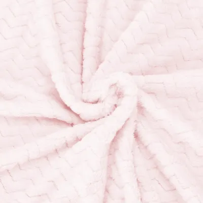 A close-up shot of a pink blanket with a zigzag pattern.