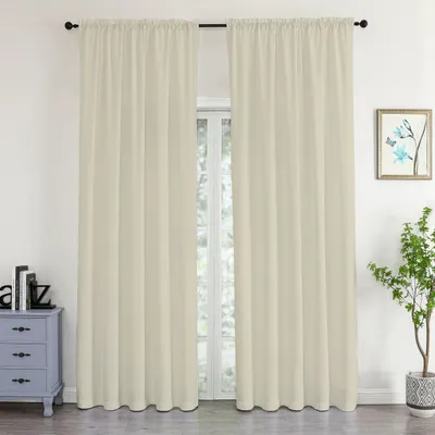 A pair of beige curtains hangs in front of a window, with a small dresser and a plant visible.