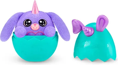 A purple plush toy unicorn bunny peeking out of a teal egg-shaped container, with the other half of the egg to the right.