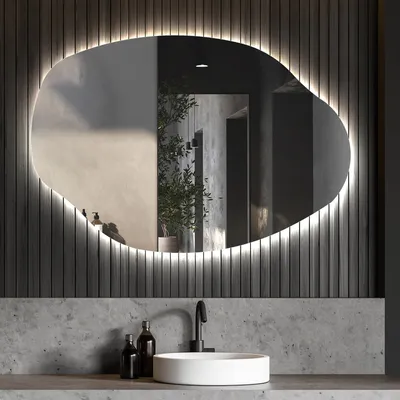 A modern bathroom vanity with a sink, faucet, and an illuminated mirror.