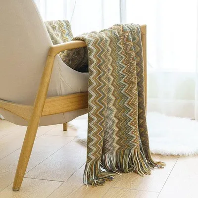 Obrázek produktu pro Unyqoos® Boho – pletená deka, 100%.Polyakryl, měkká a hřejivá, s bambulkami, jednobarevná, vhodná jako dekorační přehoz na pohovku, postel nebo jako dekorační prvek, rozměry 125 x 150 cm, barva khaki
