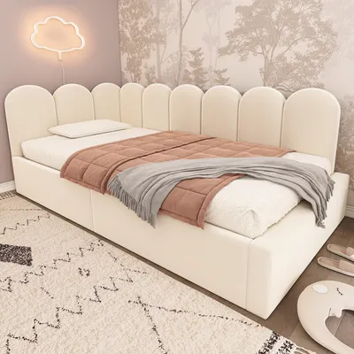 A bed with a headboard and bedding in a room with wallpaper and a cloud-shaped light.