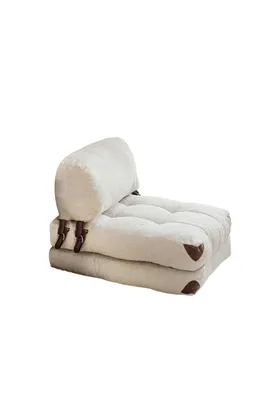 A cream-colored, tufted sofa bed with brown leather accents is shown against a white background.