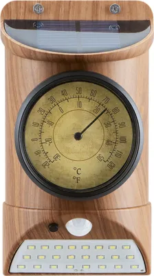 A close-up product shot of a solar-powered light with a thermometer and motion sensor, featuring a wood-grain finish.