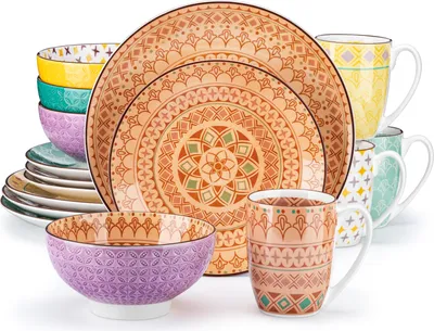 A collection of dinnerware and mugs with a bohemian-inspired pattern.