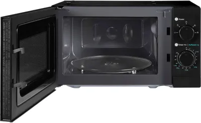An open black microwave oven with a glass turntable inside.