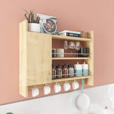 A wooden kitchen shelf unit mounted on a pink wall above a white tiled countertop.