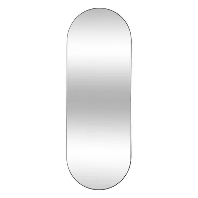 A single, full-length mirror with a rounded top and bottom.