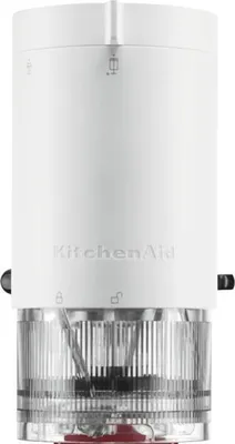 A white KitchenAid ice cream maker attachment for a stand mixer is shown against a white background.