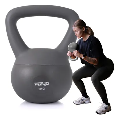 A woman is performing a squat exercise with a kettlebell, with a larger kettlebell in the foreground.