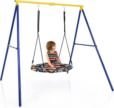A child sits on a round swing attached to a blue and yellow swing set.