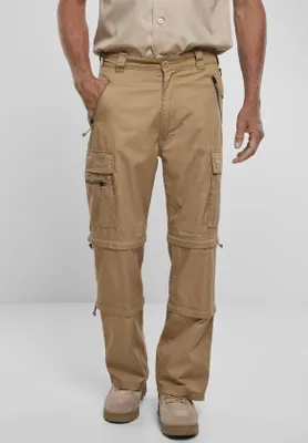 A man wearing khaki cargo pants with removable legs.