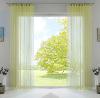 A window with light green string curtains, showing a sunny outdoor scene with a large tree.
