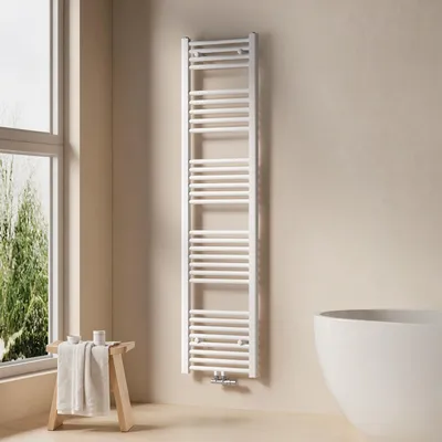 A white towel radiator is mounted on a light beige wall in a bathroom, next to a large window and a white bathtub.