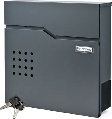 A dark gray mailbox with a newspaper compartment and keys in the foreground.