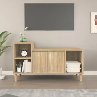 A modern living room scene featuring a wooden TV stand with storage, a large television mounted on the wall, and a potted plant on the left.