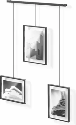 A set of three black-framed picture frames hanging from a black rail against a white background.