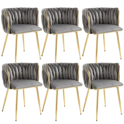 A set of six gray velvet dining chairs with gold metal frames, arranged in two rows of three.