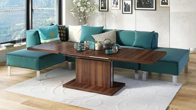 A modern living room with a teal sectional sofa and a wooden coffee table.