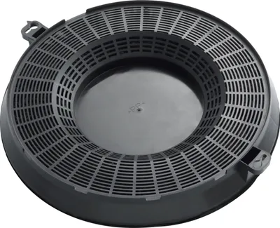 A black circular carbon filter for a kitchen hood.