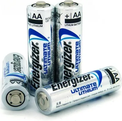 Four Energizer Ultimate Lithium AA batteries are arranged on a white background, with three standing upright and one lying horizontally in the foreground.