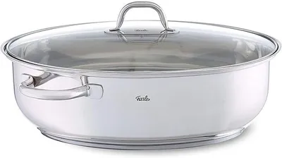 A stainless steel oval casserole dish with a glass lid and handles, shown from a side-angle on a white background.