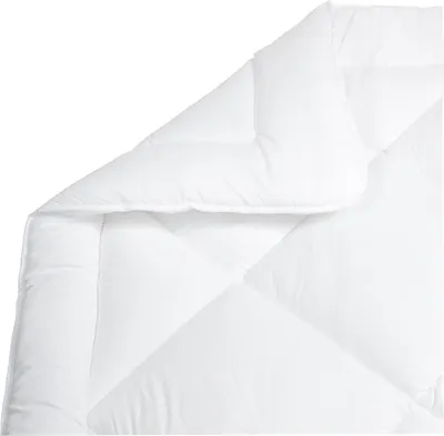 A close-up view of a white comforter, folded to show its quilted texture.