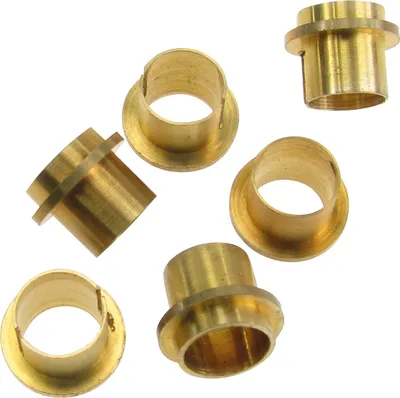 A collection of brass bushings on a white background.