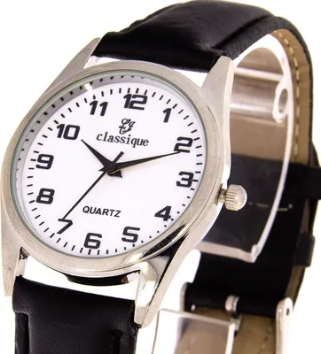 A close-up shot of a men's wristwatch with a white dial and a black leather strap.