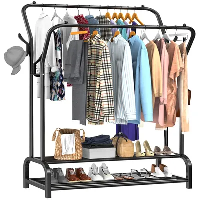 A black metal double-rod garment rack with various clothing items and accessories displayed on it, including shirts, pants, shoes, and a hat.