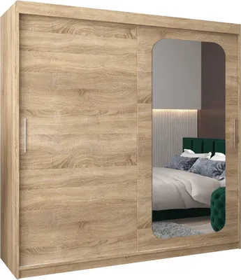 A bedroom scene reflected in the mirror of a wardrobe.