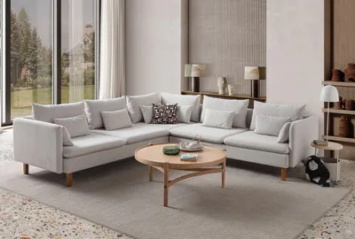 Produktbild von Hanah Home, Ecksofa in Creme, 285 x 285 x 100 cm | 70% HORNBEAM, 30% melaminbeschichtete Spanplatte | 100% Polyester (Velours) | 15 Kissen, pflegeleicht, tragbar, 240 kg Tragfähigkeit.