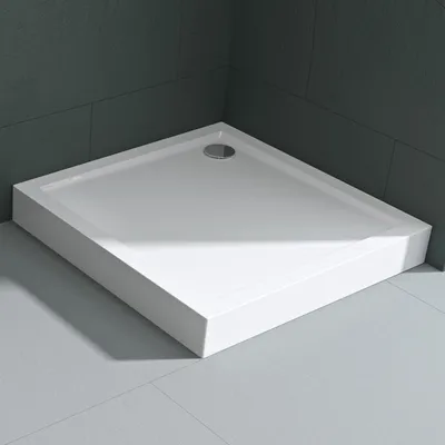 A white square shower tray is shown in a bathroom corner, with dark gray tiled walls and light gray tiled floor.