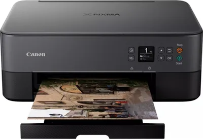 A black Canon Pixma TS5350i printer is shown from the front, printing a photograph.