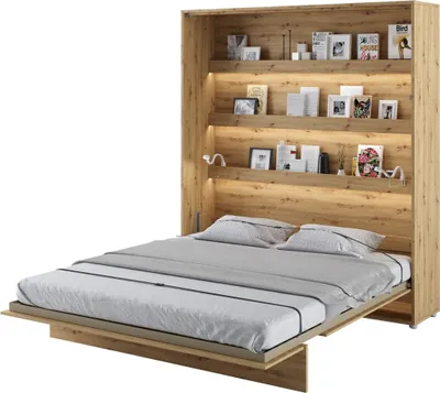 A wall bed with integrated shelving, pulled down and made up with bedding.