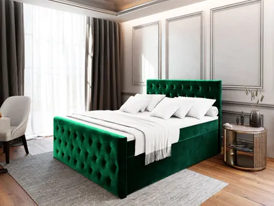 A bedroom scene with a green upholstered bed.