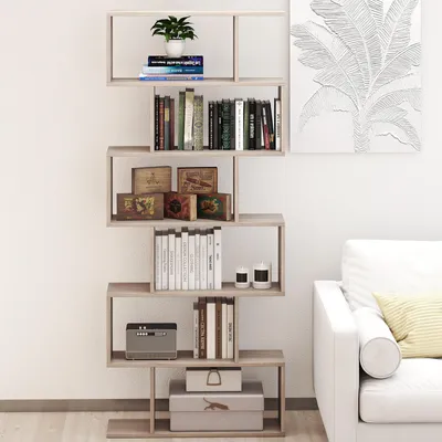 A modern, multi-tiered bookshelf filled with books and decorative items, placed against a white wall.