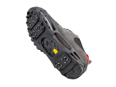 The underside of a shoe with ice cleats attached.