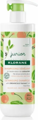 A bottle of Klorane Junior Detangling Shampoo with peach and oat.