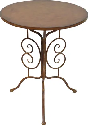 A round, rustic brown table with ornate metal scrollwork legs.