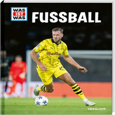 A soccer player in a yellow uniform on a green field, with a stadium in the background.