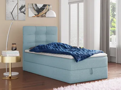 A bedroom scene with a bed, nightstand, and lamp.