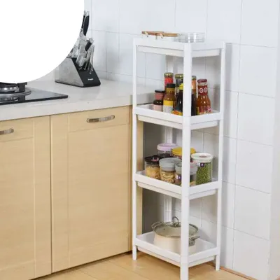 A white plastic shelving unit filled with jars and bottles in a kitchen setting.
