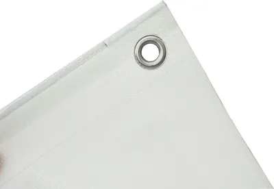 A close-up view of the corner of a white tarp, showing a metal grommet.