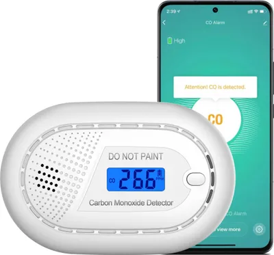 A carbon monoxide detector and a smartphone displaying a CO alarm notification.