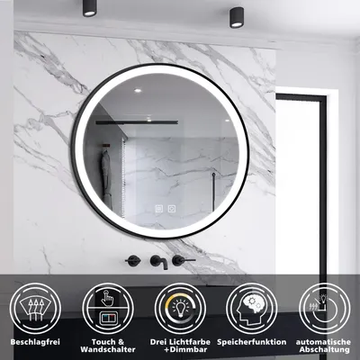 A round LED bathroom mirror with a black frame is mounted on a marble-tiled wall. Below the mirror are icons and text describing its features.