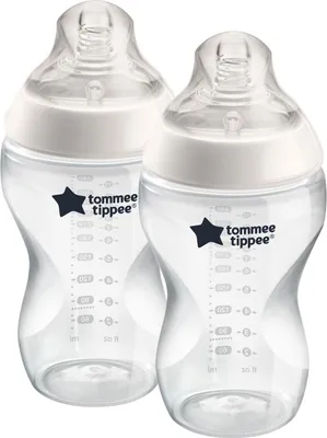 Two clear baby bottles with white caps and measurement markings.