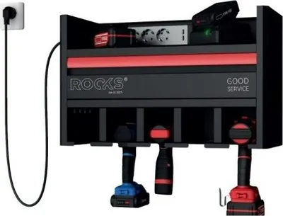 A tool organizer with power tools hanging from it, plugged into a wall outlet.