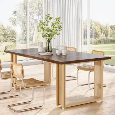 A dining table set in a bright, modern room with large windows overlooking a garden.